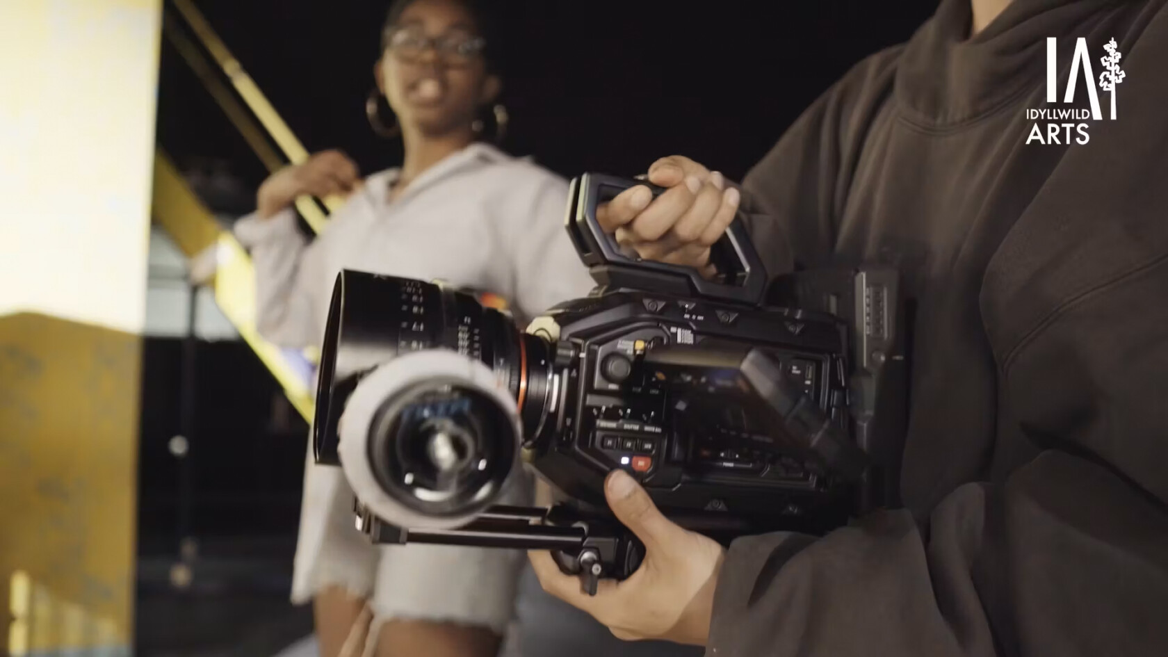 Film and digital media students using a video camera.